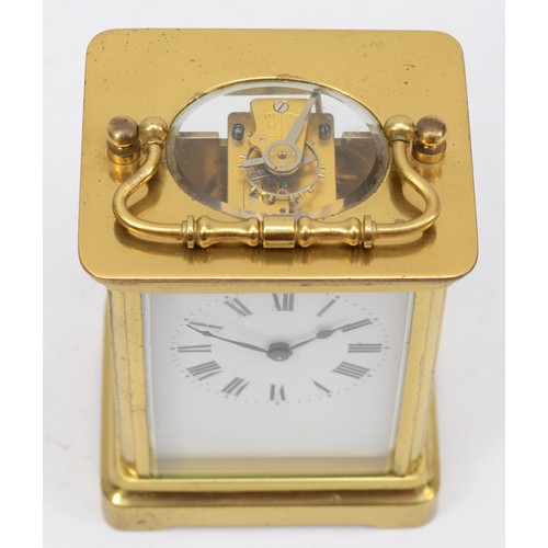 334 - A 20th century corniche brass cased and four glass carriage clock, with swing handle the white dial ... 