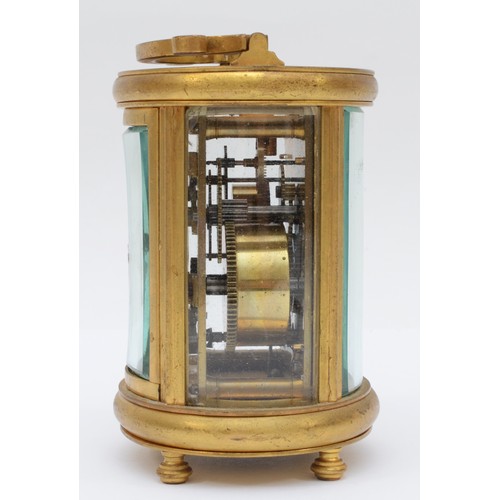 348 - A 20th century oval brass cornice cased and four glass carriage clock, with swing handle, the white ... 