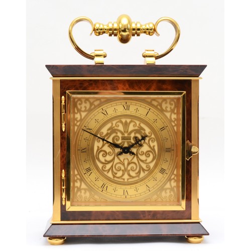 353 - Luxor, a contemporary brass mantle clock, the brass dial with black Roman numerals and scroll decora... 