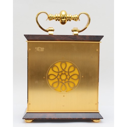 353 - Luxor, a contemporary brass mantle clock, the brass dial with black Roman numerals and scroll decora... 