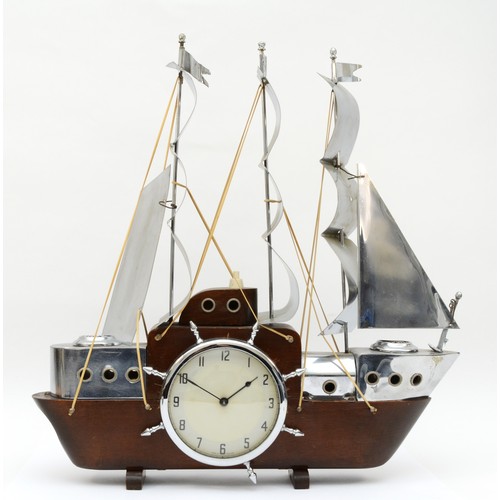 355 - A mid 20th century mahogany and chrome plated mantle clock modelled in the form of a three mast sail... 