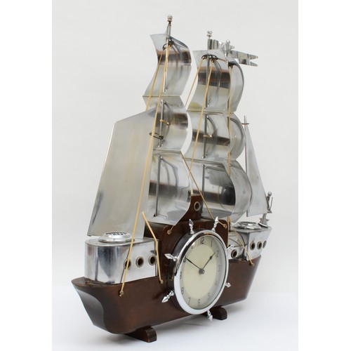 355 - A mid 20th century mahogany and chrome plated mantle clock modelled in the form of a three mast sail... 