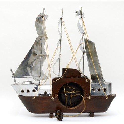 355 - A mid 20th century mahogany and chrome plated mantle clock modelled in the form of a three mast sail... 