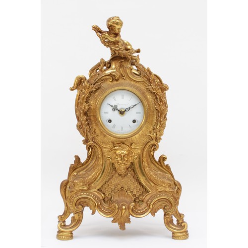 356 - Imperial, a 20th century gilt brass cartouche shaped mantle clock, cast with putti finial and acanth... 