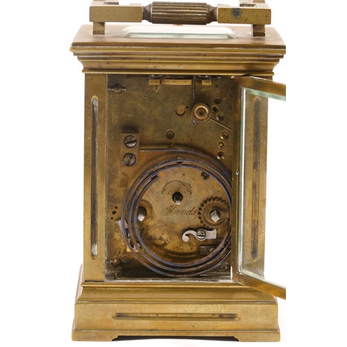 366 - An early 20th century French brass and four glass corniche cased striking carriage clock, with swing... 