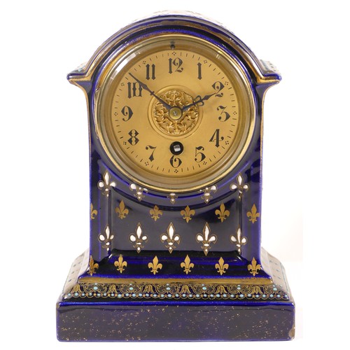 371 - An early 20th century cobalt blue cased dome topped porcelain cased mantle clock, decorated with gil... 