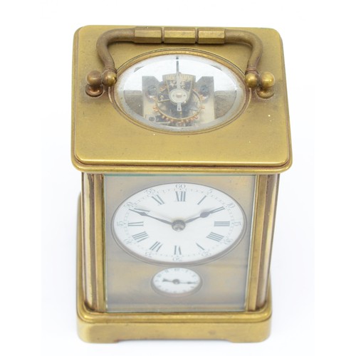 372 - An early 20th century brass and four glass corniche cased striking carriage clock, the white enamell... 