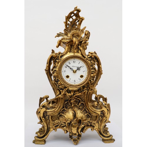 375 - Korslant, a late 19th/early 20th century gilt brass cartouche shaped mantle clock, the white painted... 