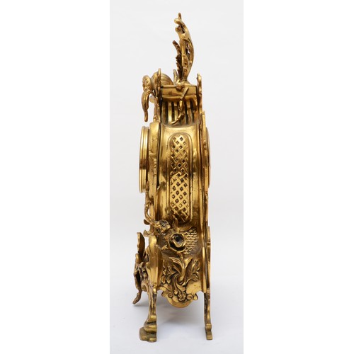 375 - Korslant, a late 19th/early 20th century gilt brass cartouche shaped mantle clock, the white painted... 