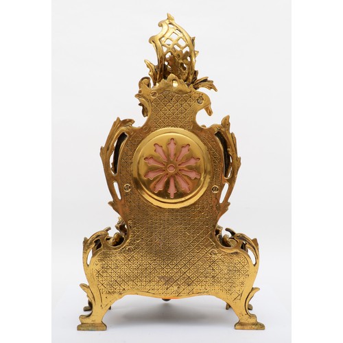 375 - Korslant, a late 19th/early 20th century gilt brass cartouche shaped mantle clock, the white painted... 