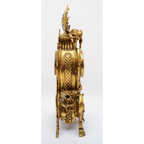 375 - Korslant, a late 19th/early 20th century gilt brass cartouche shaped mantle clock, the white painted... 