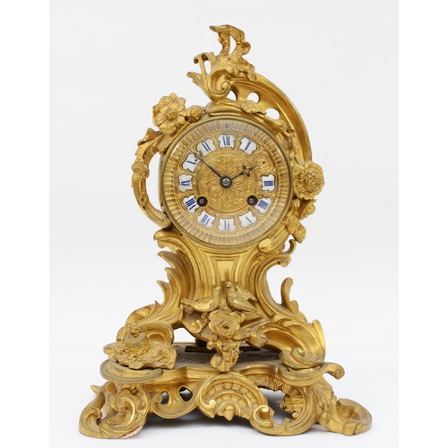 376 - A late 19th century, probably French gilt brass mantle clock, the gilt dial with applied enamel Roma... 