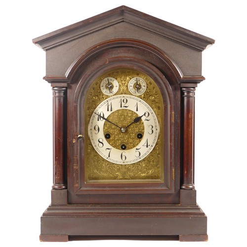 383 - A late 19th/early 20th century mahogany cased architectural mantle clock, the brushed steel chapter ... 