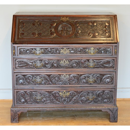 436 - A late 19th century carved mahogany fall front bureau, opening to reveal fitted interior with four g... 