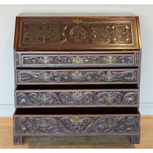 436 - A late 19th century carved mahogany fall front bureau, opening to reveal fitted interior with four g... 