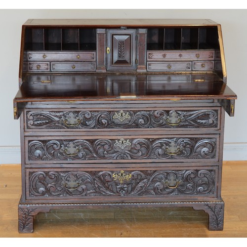 436 - A late 19th century carved mahogany fall front bureau, opening to reveal fitted interior with four g... 