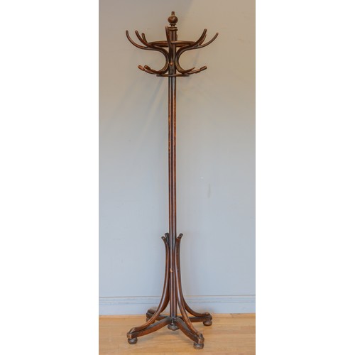 437 - A 20th century Thonet style Bentwood hat and coat stand, raised on four outswept supports terminatin... 