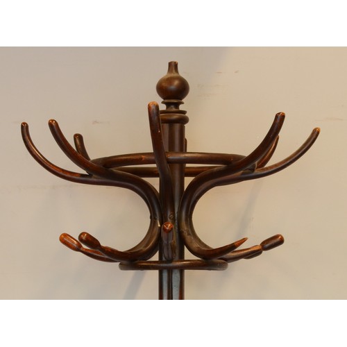 437 - A 20th century Thonet style Bentwood hat and coat stand, raised on four outswept supports terminatin... 