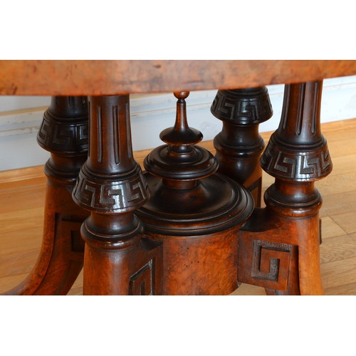 439 - A late Victorian inlaid walnut oval loo table stamped Bros, raised on quadruple carved Greek Key and... 