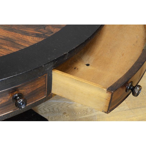 440 - A 19th century Rosewood circular drum table, raised on central fluted urn support standing quad base... 