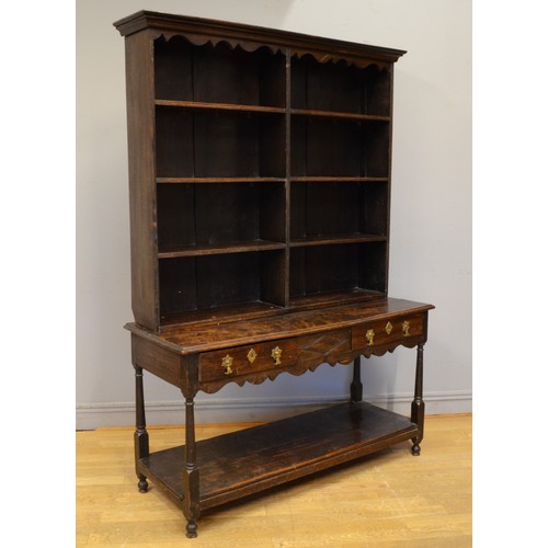 444 - A George III and later adapted oak dresser, with open shelf back raised on twin drawer base with bra... 