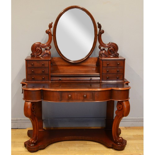 445 - A late 19th century mahogany Dutch style dressing table, with an oval swing mirror flanked by two ba... 