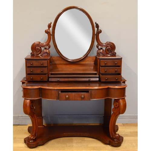 445 - A late 19th century mahogany Dutch style dressing table, with an oval swing mirror flanked by two ba... 