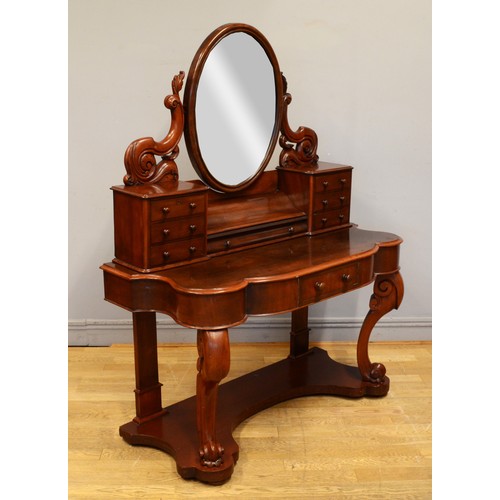 445 - A late 19th century mahogany Dutch style dressing table, with an oval swing mirror flanked by two ba... 