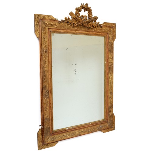 454 - A 19th century gilt painted hanging bevel edged wall mirror, with carved laurel wreath and stylised ... 