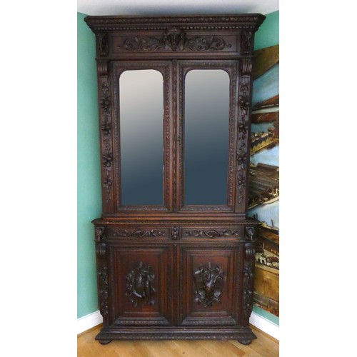 457 - A 19th century heavily carved oak corner cupboard, with two glass doors opening to reveal three adju... 