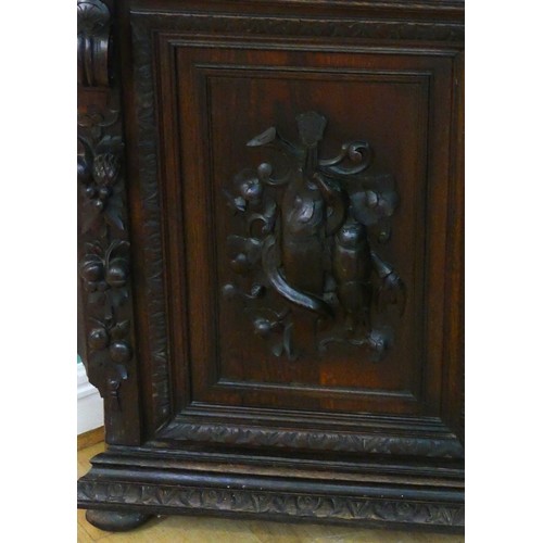 457 - A 19th century heavily carved oak corner cupboard, with two glass doors opening to reveal three adju... 