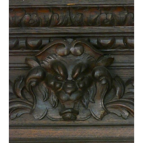 457 - A 19th century heavily carved oak corner cupboard, with two glass doors opening to reveal three adju... 