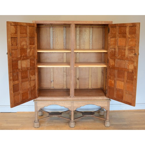 460 - A 20th century carved oak twin panelled door cupboard (converted from a tallboy) the doors with late... 