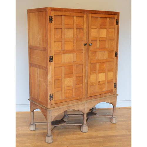 460 - A 20th century carved oak twin panelled door cupboard (converted from a tallboy) the doors with late... 