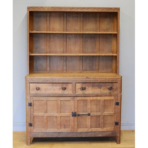 465 - Peter 'Rabbitman' Heap, a mid 20th century adzed oak Welsh style dresser, the panelled upper section... 