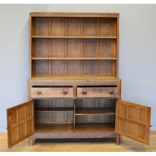 465 - Peter 'Rabbitman' Heap, a mid 20th century adzed oak Welsh style dresser, the panelled upper section... 