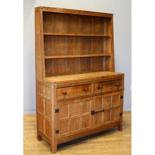 465 - Peter 'Rabbitman' Heap, a mid 20th century adzed oak Welsh style dresser, the panelled upper section... 