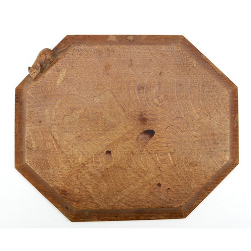 472 - Robert 'Mouseman' Thompson of Kilburn, a 20th century oak octagonal chopping board with carved mouse... 