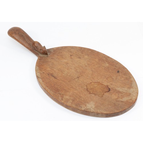 473 - Robert 'Mouseman' Thompson of Kilburn, a mid 20th century oval shaped cheeseboard, with carved mouse... 