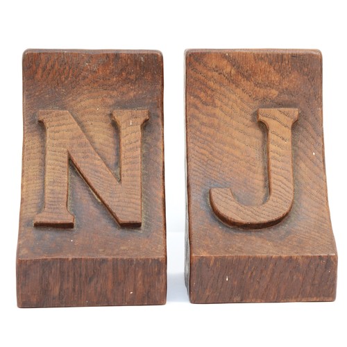 478 - Robert 'Mouseman' Thompson of Kilburn, a pair of mid 20th century carved oak adzed bookends, each wi... 