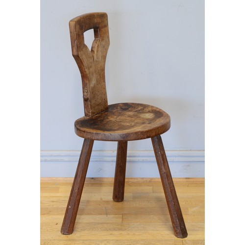 488 - Robert 'Mouseman' Thompson, a 20th century carved oak three legged spinning chair, with carved pierc... 