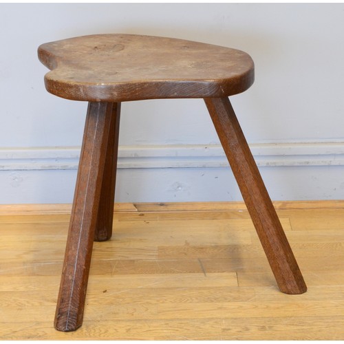 489 - Robert 'Mouseman' Thompson of Kilburn, a 20th century slightly adzed carved oak stool, with shaped s... 