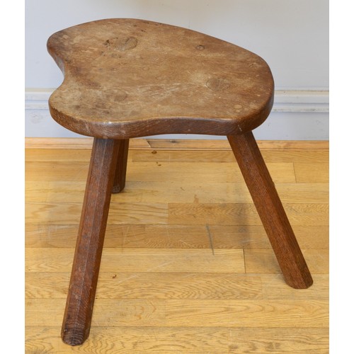 489 - Robert 'Mouseman' Thompson of Kilburn, a 20th century slightly adzed carved oak stool, with shaped s... 