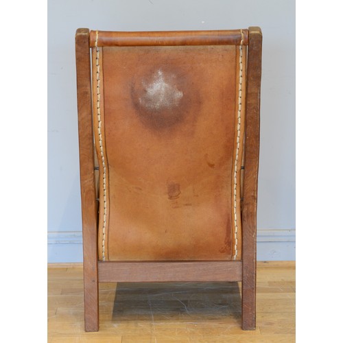 491 - Robert 'Mouseman' Thompson of Kilburn, a mid 20th century carved oak smoking chair with brown leathe... 