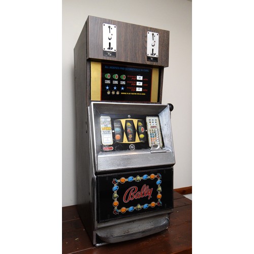 502 - Bally, an electromechanical three reel and hold slot machine, c.1965/70, with 20p and £1 change abov... 