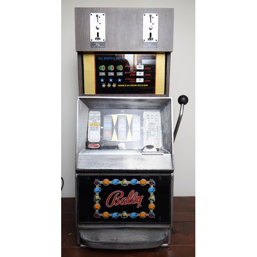 502 - Bally, an electromechanical three reel and hold slot machine, c.1965/70, with 20p and £1 change abov... 