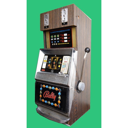 502 - Bally, an electromechanical three reel and hold slot machine, c.1965/70, with 20p and £1 change abov... 