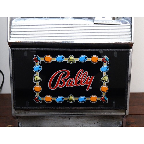 502 - Bally, an electromechanical three reel and hold slot machine, c.1965/70, with 20p and £1 change abov... 