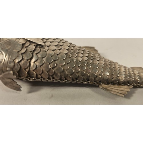 57 - An unmarked silver articulated fish, with hinged head and flexible body, 19cm, 114gm, and two other ... 