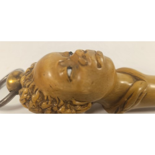 269 - A 19th century carved horn carving steel or poker, the handle in the form of an Afro Caribbean lady,... 